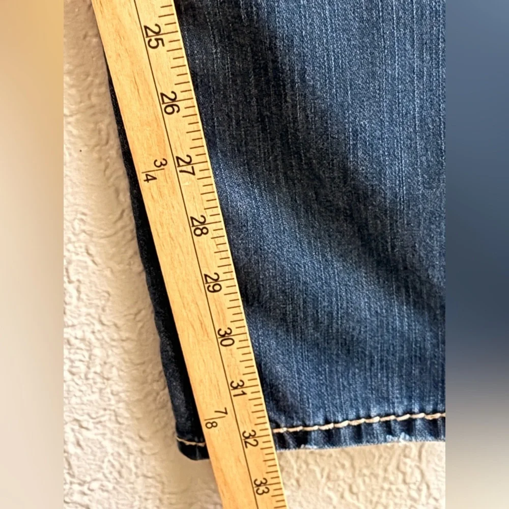 True Religion jeans feature a dark wash and bold signature stitching. Skinny